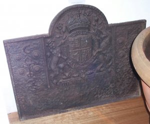 CAST IRON FIRE BACK bearing the coat of arms of Charles 11. Dated 1662.