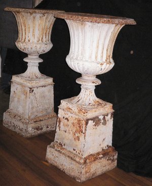 909  A large and impressive pair of cast iron urns