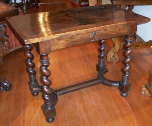 272 A small walnut side table with shaped H stretche
