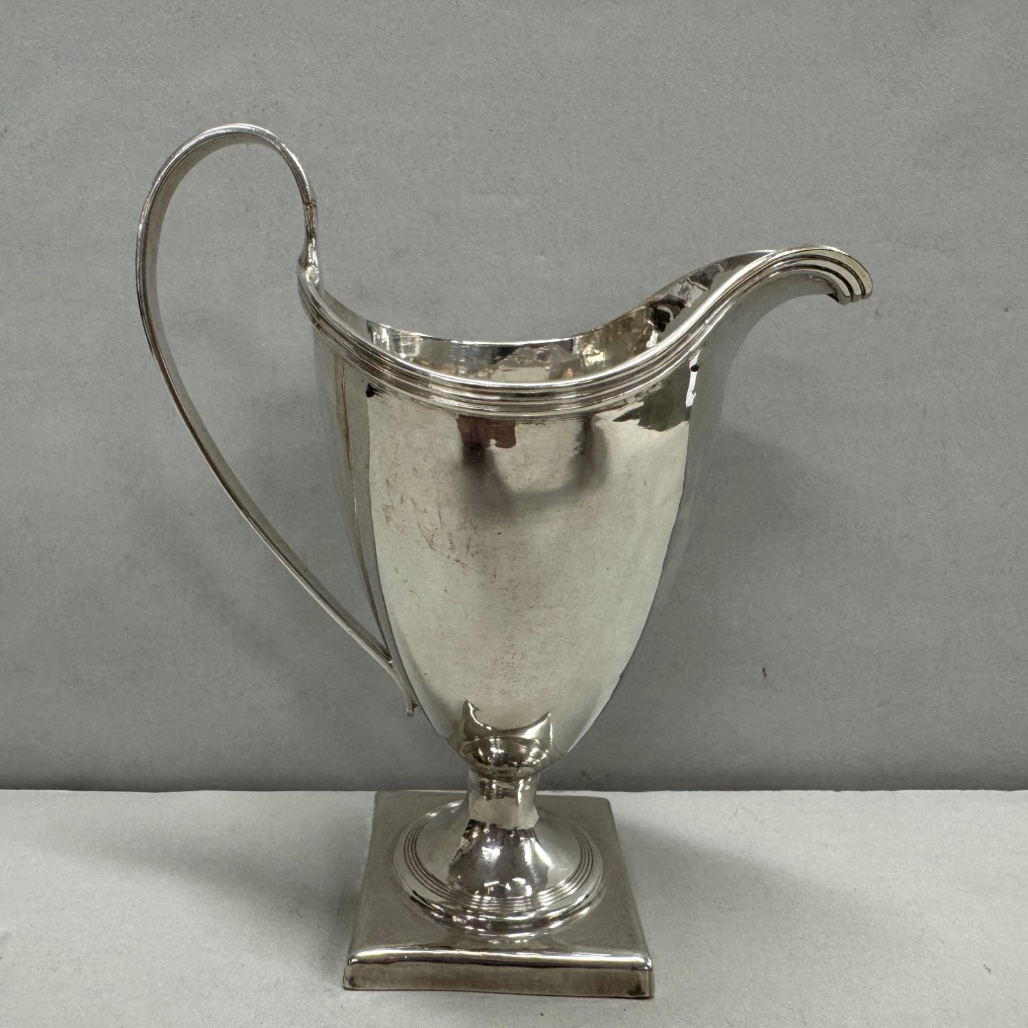 A George III Sterling Silver Square Base Cream Jug