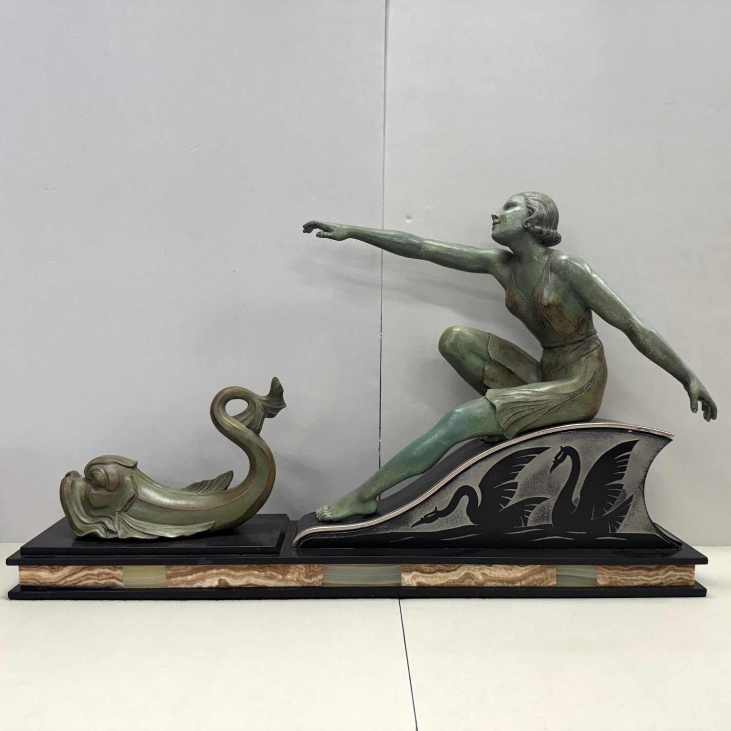 A French Art Deco Athletic Girl with Dolphin and Swan Figurine 