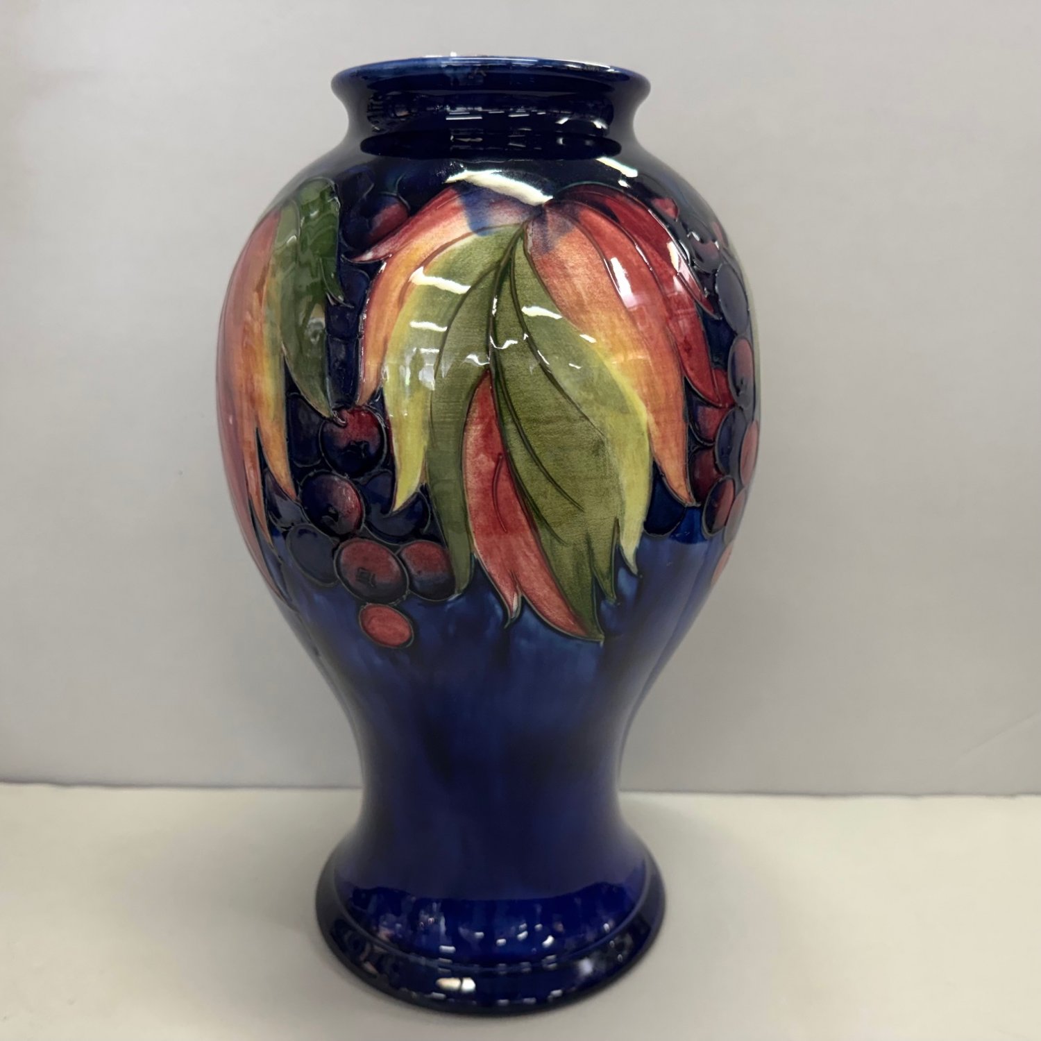 A Walter Moorcroft Vase in 'Leaf and Berry' Pattern.