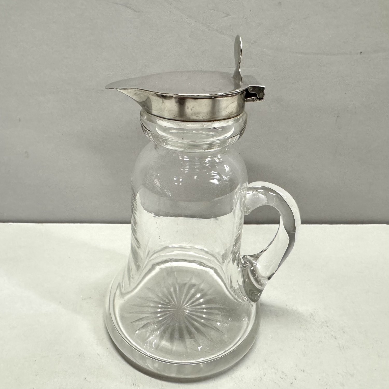 A Sterling Silver Mounted Cut Crystal Whisky Jug
