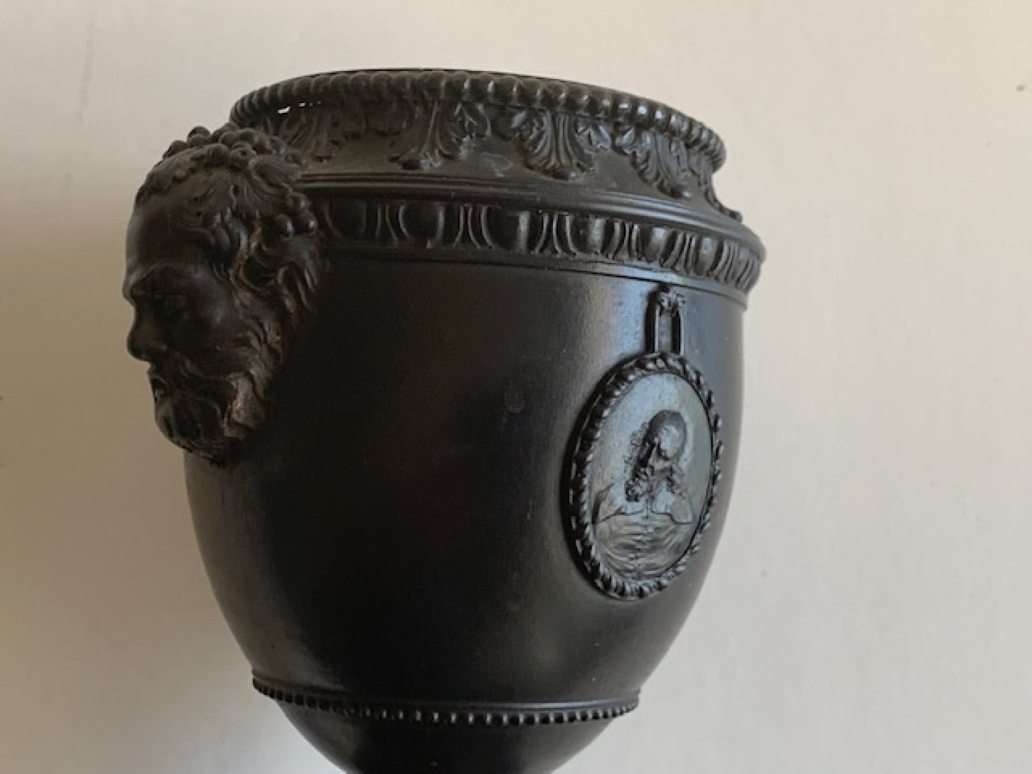 John Neale of Hanley black basalt shield shape vase on square pedestal foot