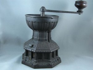 A Cast iron coffee grinder, designed by Christopher Dresser