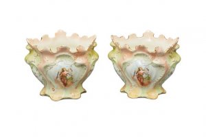 Antique pair of ceramic jardinieres, painted in pastel shades and featuring angels 