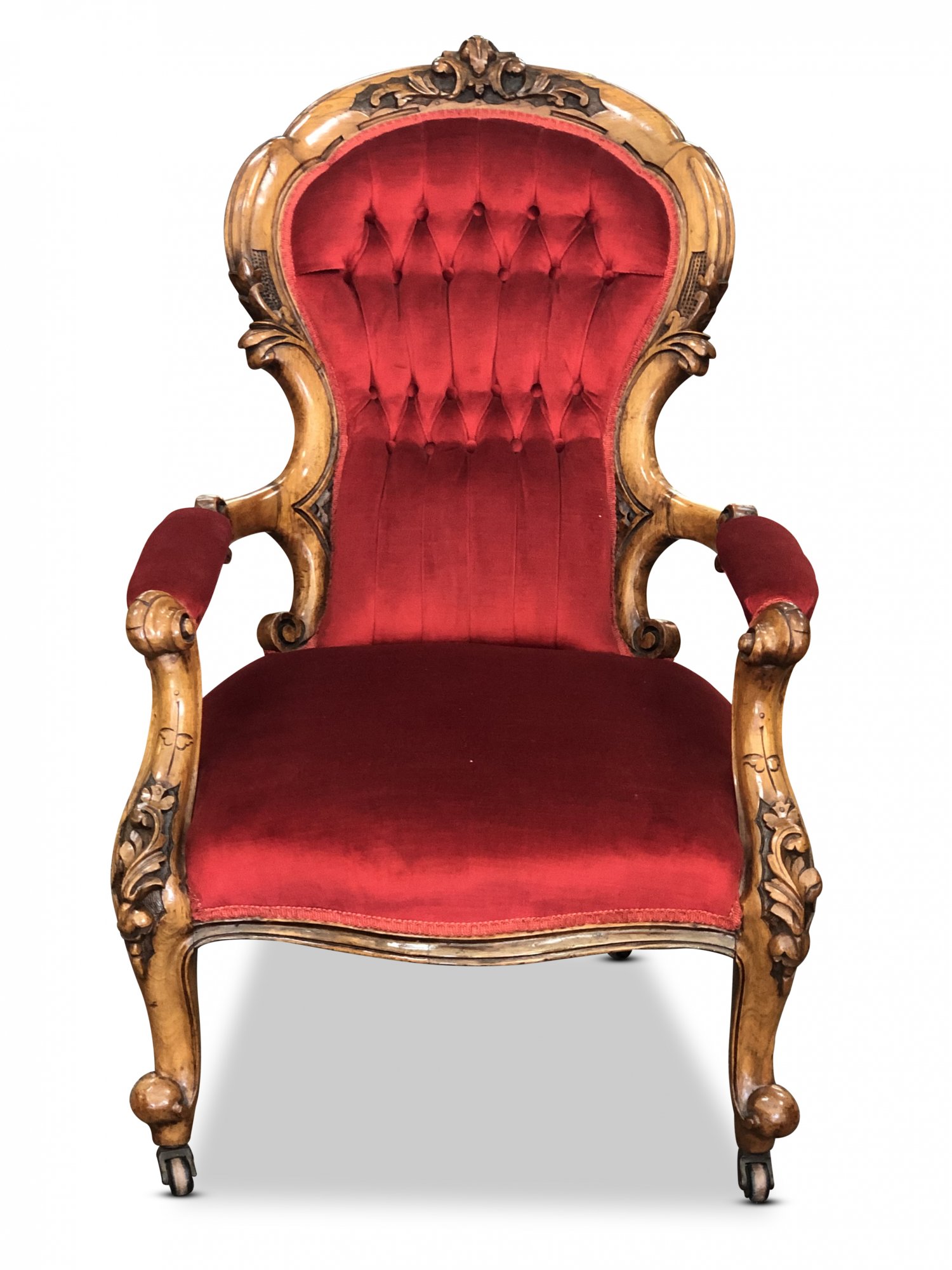 Victorian ornately carved walnut gentleman’s chair, with red velvet upholstery featuring deep diamond buttoning