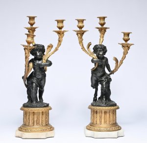 An Exceptional Pair of French Louis XVI Style Patinated and Gilt Bronze Three-Light Candelabra, after Clodion. Circa 1830.