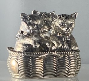 A Victorian novelty silver cat cruet, to include mustard pot and two casters. Robert Hennell, London 1860. $18,000.