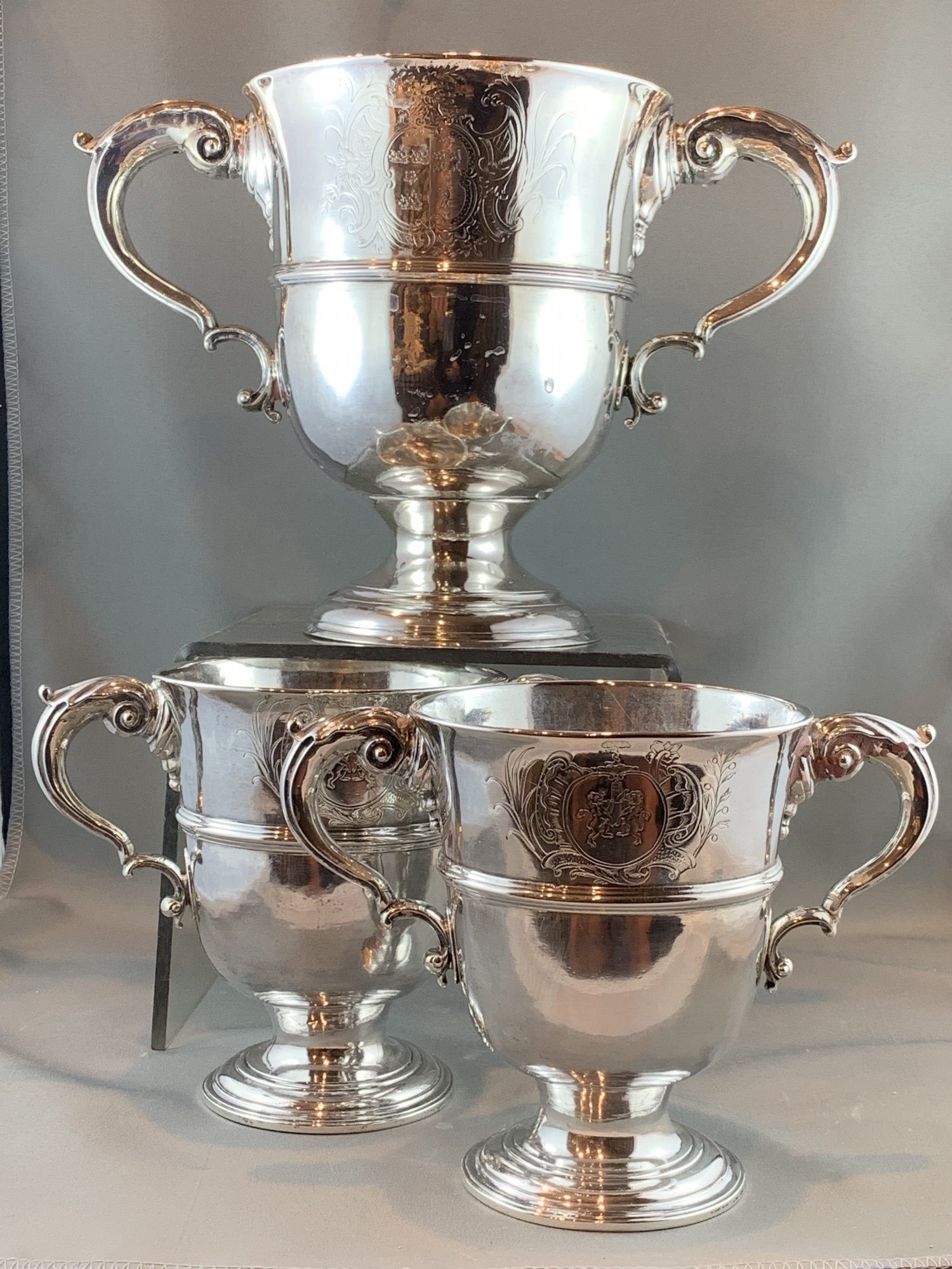 Malcolm Fraser Interest. Ex. Property of the family of Malcolm Fraser.  A suite of three 18th century Irish silver two handle cups. Each with contemporary coat of arms. Dublin, c.1750.  Provenance: Sotheby’s, December 1994, lot 699 and 670.  Price for the collection: $16,000.