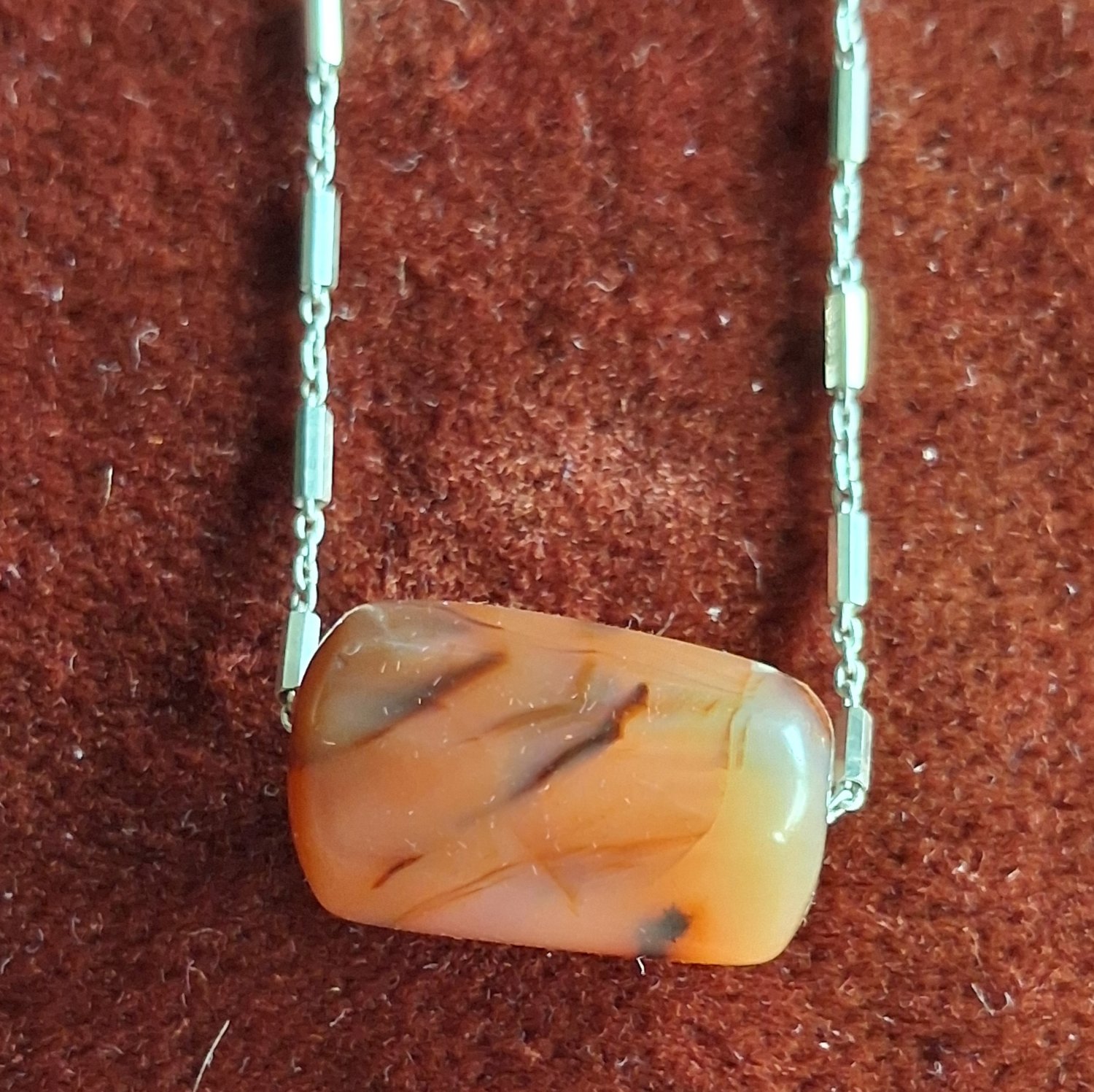 A silver chain necklace with a fine antique agate bead