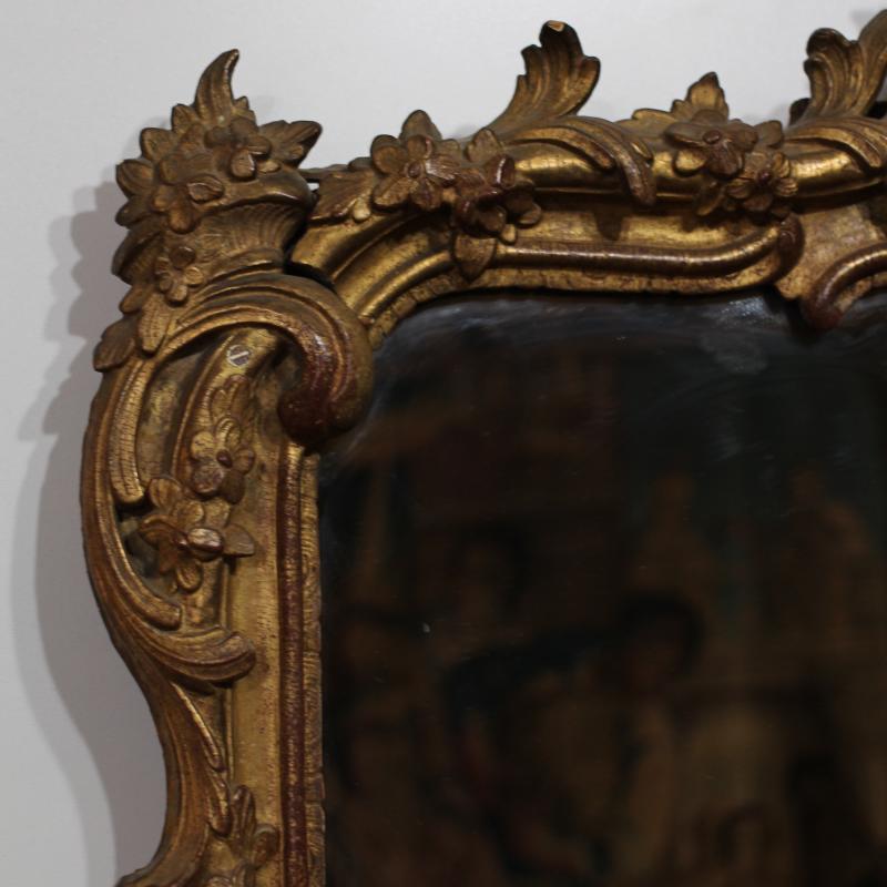 AN EARLY 18TH CENTURY, REGENCE GILTWOOD MIRROR.