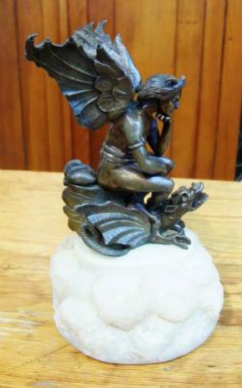 BRONZE MYTHICAL WINGED FIGURE ON A DRAGON